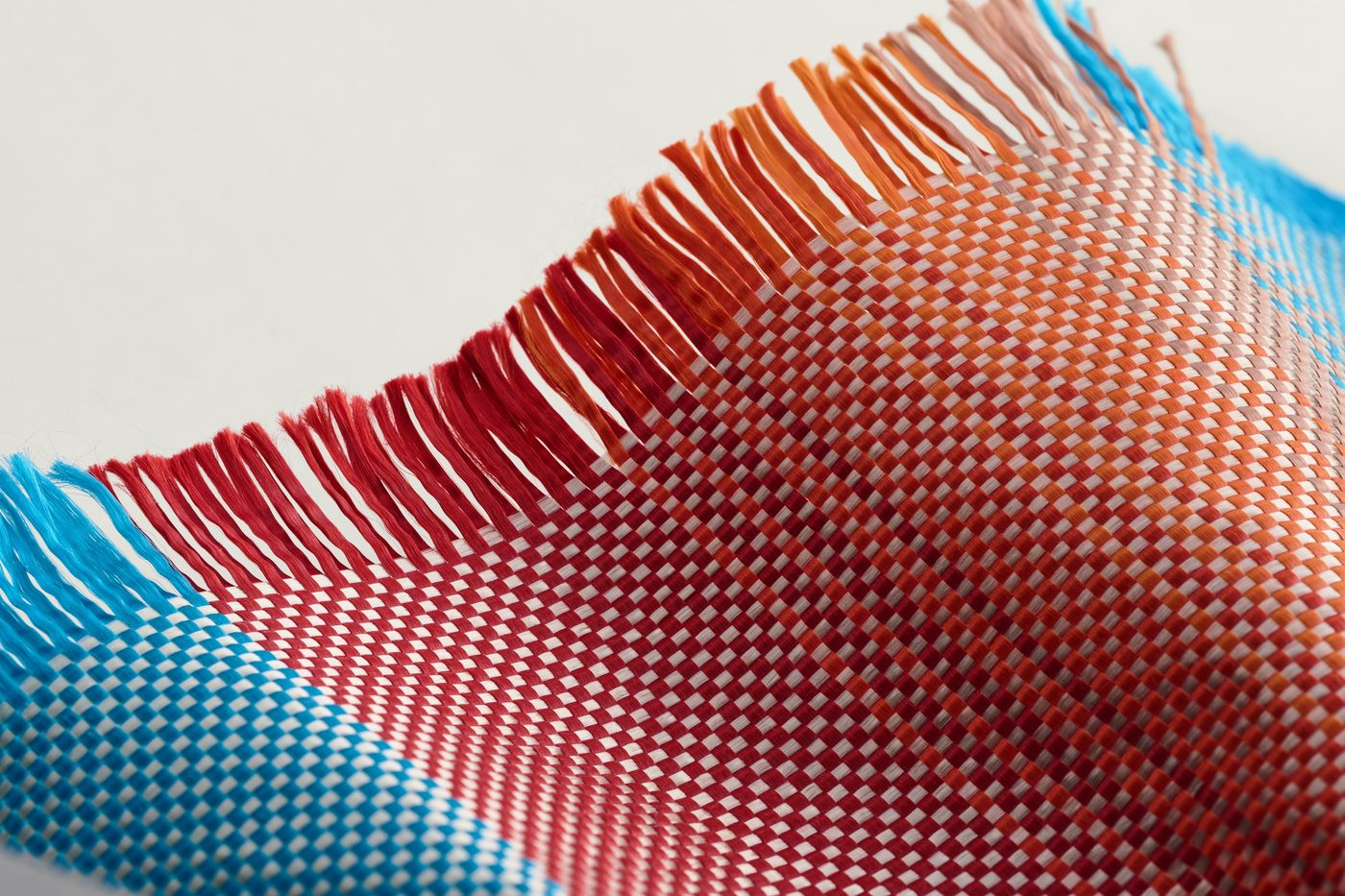 Close-up of PITAKA's woven aramid in red and blue